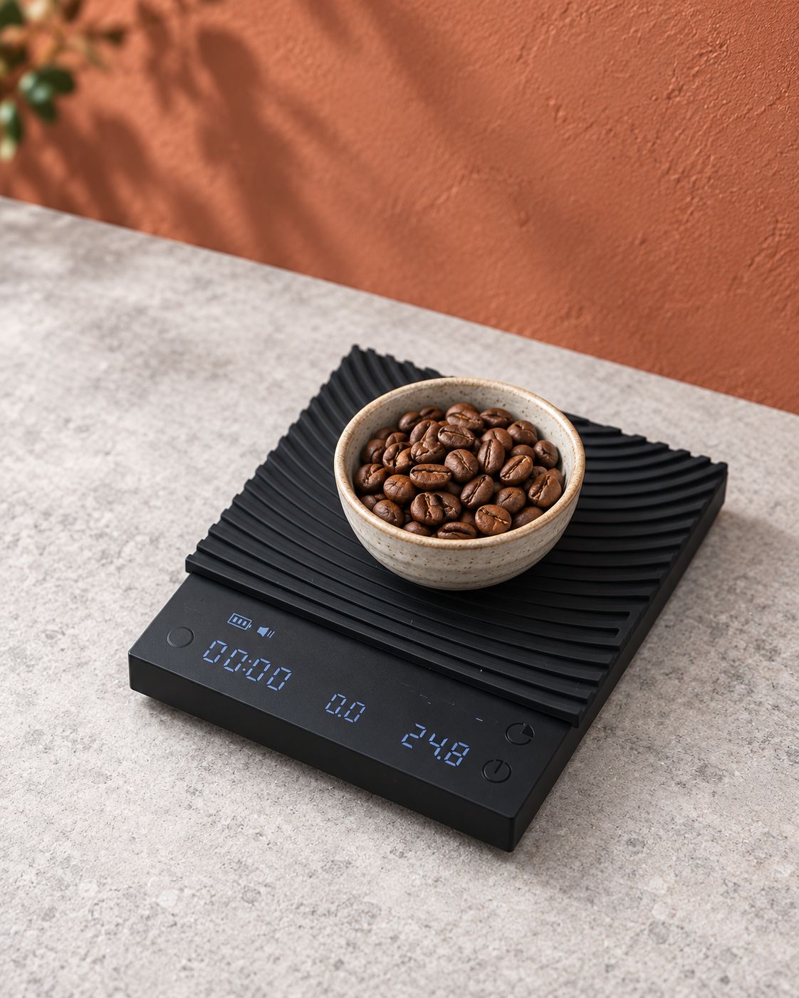 Black coffee scale with a ridged silicone pad, holding a bowl of coffee beans