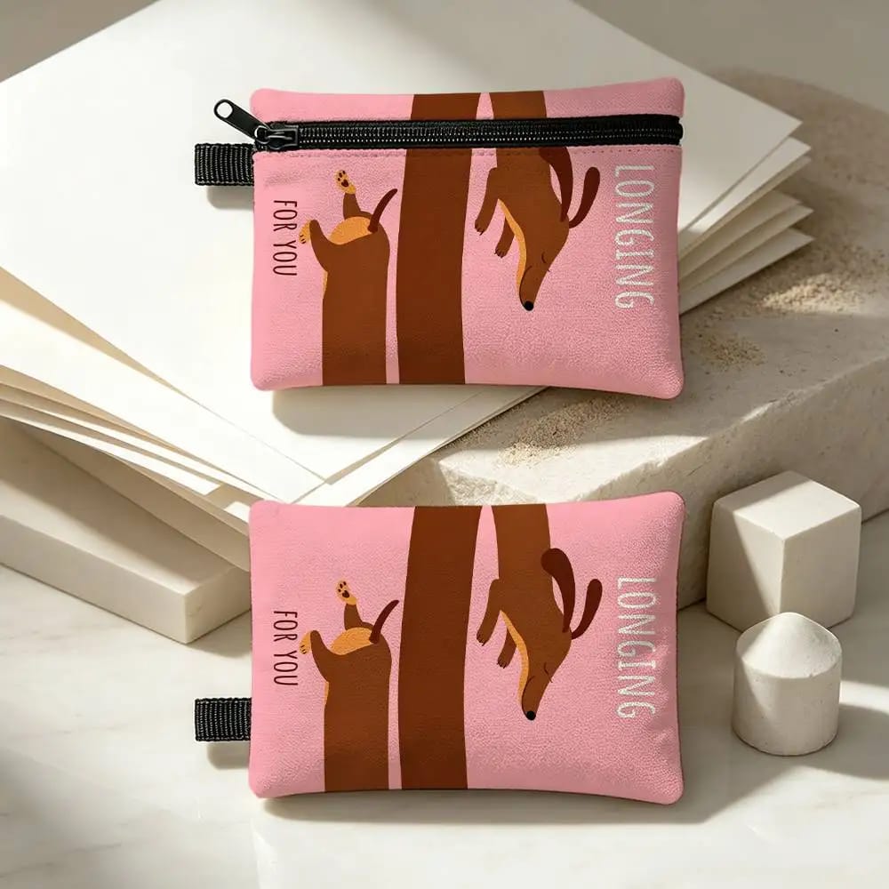 Front and back of a pink zippered pouch printed with a long brown dachshund and the words “Longing for you”