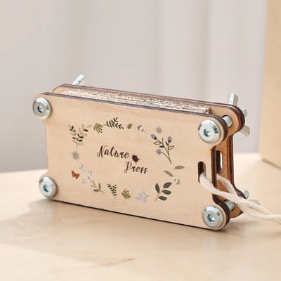Pocket flower press standing on its side, showing the layered construction.