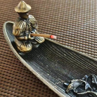Fisherman Boat Incense Holder: Fisherman and incense grip detail