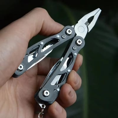Folding Multitool with Pouch: Pliers held in the hand