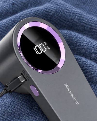 Close-up of the grey shaver display and charging cable connection.