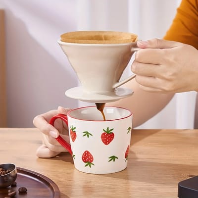 White Ceramic Pour-Over Dripper: Lifting the dripper by its handle