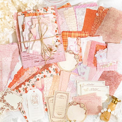Pink Scrapbook Paper Assortment: Close-up of the pink paper and label assortment